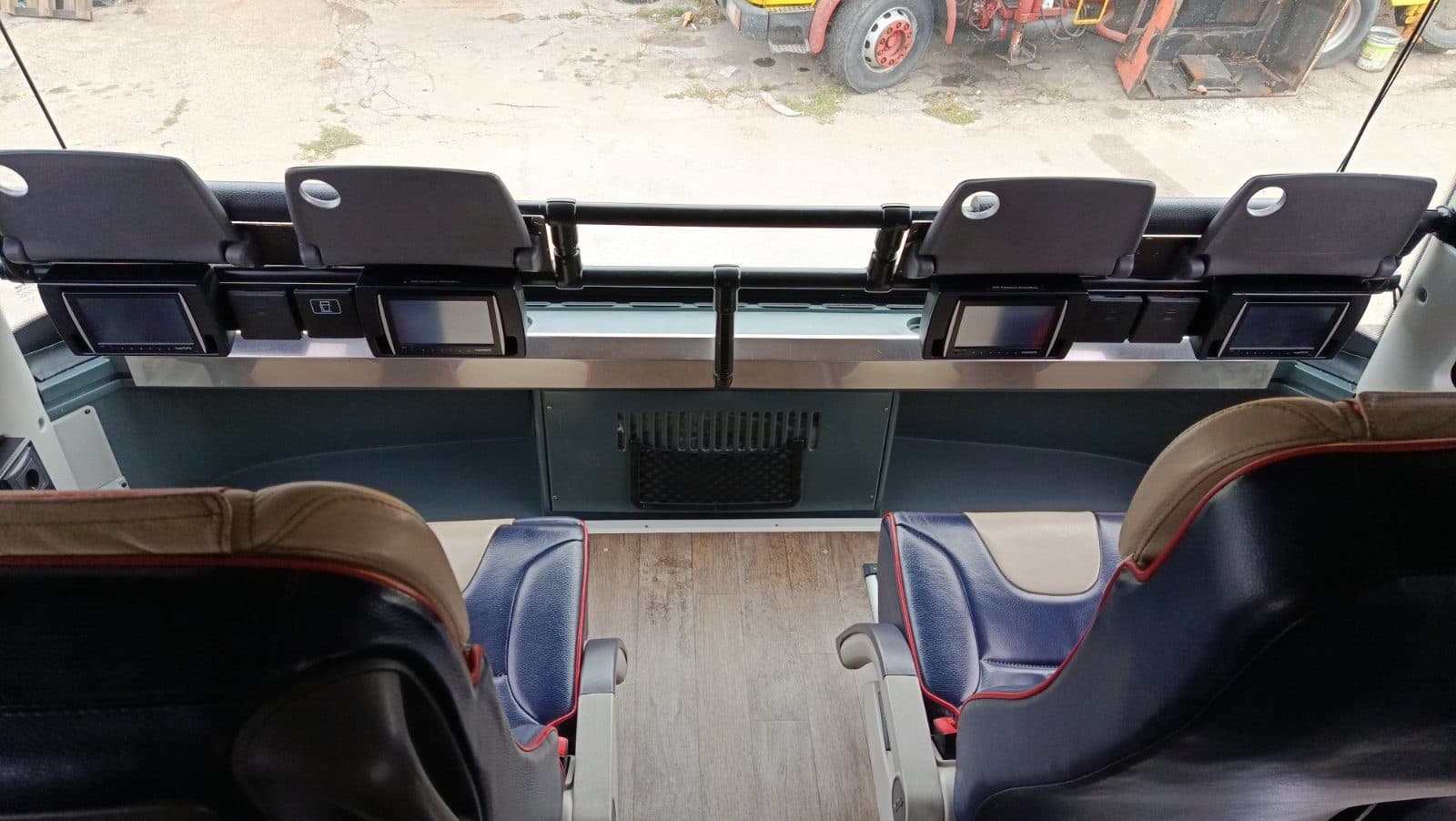 Front seats on the upper deck of the VIP coach with screens